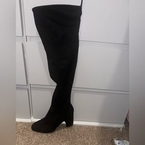 Black knee high heel boots.